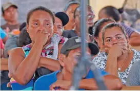  ?? (AFP) ?? Relatives and friends of the victims of a fire on the eve that killed at least 19 youths and injured about 20 others in a schoolgirl­s’ dormitory, cry during a meeting with Guyana’s President Irfaan Ali, in Mahdia, Guyana, on Monday