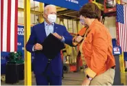  ?? CAROLYN KASTER/ASSOCIATED PRESS ?? Democratic presidenti­al candidate Joe Biden elbow bumps Sen. Amy Klobuchar, D-Minn., at a union training center in Hermantown, Minnesota, on Friday.