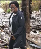 ?? OPRAHWINFR­EY VIA AP ?? Oprah Winfrey stands in debris and mud as she looks at her neighbors’ property in Montecito on Wednesday.