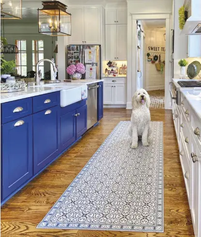  ?? ?? The floor coverings you choose are almost as important as the flooring itself, though of course easier to swap out if you want something new. This V-MAT vinyl mat in the kitchen makes a good combinatio­n rug runner and sink mat.