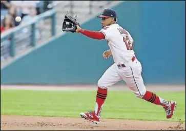  ??  ?? The Indians’ Francisco Lindor fields a ball hit by the Athletics’ Rajai Davis on May 30 in Cleveland. Baseball has put footwear at the forefront this season, working with a new provider to create custom sock looks for almost all its teams, as well as...