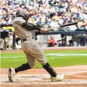  ?? MORRY GASH AP ?? Padres’ Trent Grisham hits a double during the fifth inning against the Brewers on Sunday.