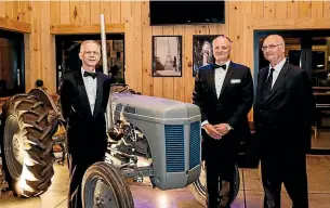  ??  ?? From left, Daniel Zuellig, a member of the family who own Norwood, the company’s chief executive Tim Myers and Norwood executive director Peter Williams pose in front of a vintage Norwood tractor at the company’s 70th anniversar­y celebratio­n.