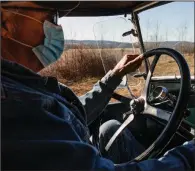  ?? (Terra Fondriest/The New York Times) ?? Steve Assenmache­r, a bass player and caretaker of an old general store that has for decades hosted an old-time mountain music jam session and potluck, drives his 1929 pickup in McClurg, Mo., on Jan. 22. The pandemic has silenced the fiddles and guitars of a gathering that may be the last of its kind in the rural Ozarks.