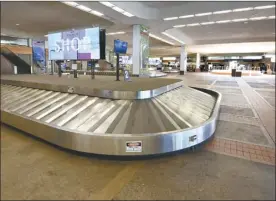  ?? The Maui News / MATTHEW THAYER photo ?? Kahului Airport’s baggage claim area is deserted in April. Gov. David Ige expressed confidence Wednesday that the state will move forward with its pre-travel testing plan on Oct. 15, though some Neighbor Island counties have considered opting out. Maui County said Wednesday it is moving forward with the plan.