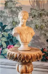  ??  ?? ABOVE RIGHT A carved marble stand holds a classical Parian bust.