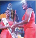  ??  ?? The Hon Juliet Holness (right) makes the presentati­on to Miss Festival Queen, Dainalyn Swaby.