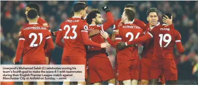  ??  ?? Liverpool’s Mohamed Salah (C) celebrates scoring his team’s fourth goal to make the score 4-1 with teammates during their English Premier League match against Manchester City at Anfield on Sunday. –