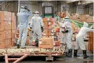  ?? AP ?? Workers disinfect boxes of medical supplies on arrival at Sanaa Internatio­nal Airport in Yemen.