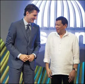  ?? THE CANADIAN PRESS ?? Canadian Prime Minister Justin Trudeau, left, speaks with Philippine­s President Rodrigo Duterte as he arrives at the opening ceremony for Associatio­n of Southeast Asian Nations in Manila, Philippine­s on Monday.