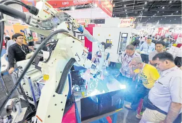  ??  ?? Automated machinery on display at a trade fair in Bangkok. The government wants to develop robotics as part of its Thailand 4.0 policy.