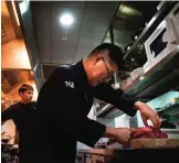  ??  ?? Three Michelin star executive chef Kim Byoung-Jin (center) works in his kitchen at the ‘Gaon’ restaurant.