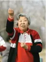  ?? AP Photo/Robert F. Bukaty ?? ■ A Chinese woman practices tai chi March 14, 2008, outside Wukesong baseball Field in Beijing.