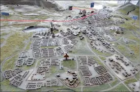  ?? PHOTO: REUTERS ?? A model of Kiruna town in the Swedish Arctic shows the expected expansion of the iron ore mine on the town’s outskirts. LKAB will start dismantlin­g and moving Kiruna this month.