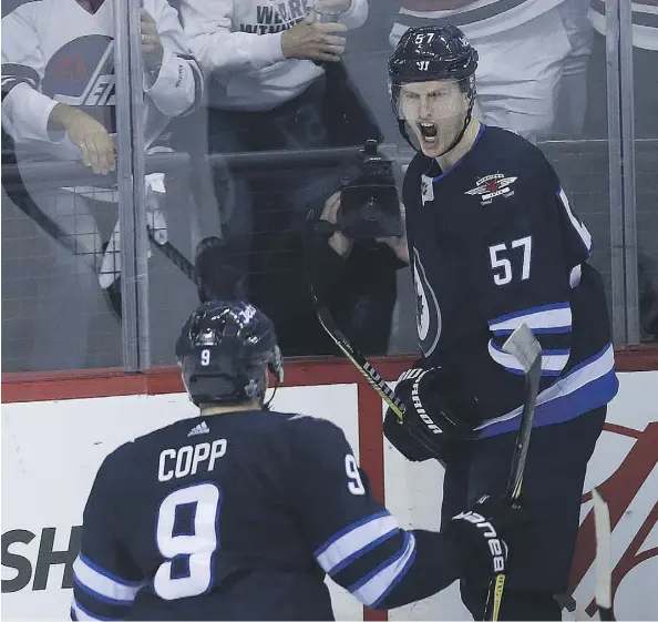  ?? KEVIN KING ?? Winnipeg Jets defenceman Tyler Myers celebrates his goal with Andrew Copp during Game 2 against the Minnesota Wild Friday in Winnipeg. The Jets went on to record a 4-1 victory to take a 2-0 lead in the best-of-seven series, which shifts to St. Paul,...