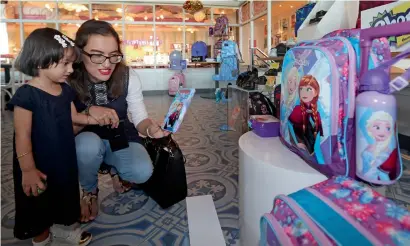  ?? Photo by Dhes Handumon ?? A mother and her daughter check back-to-school collection displayed at a leading store at the Dubai Festival City on Tuesday. With hardly a month left for school reopening, parents are busy calculatin­g their budget and buying stuff. —