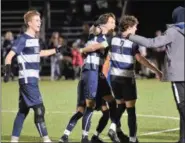  ?? AUSTIN HERTZOG - DIGITAL FIRST MEDIA ?? Hale Lombard, left, Euan Forrest, second from left, and Aidan Sullivan (3) join the celebratio­n after Hill defeated Mercersbur­g Academy 2-0 in a PAISAA semifinal Thursday.