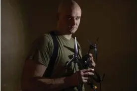  ?? ?? Gleb Molchanov, a drone operator shows off a Chinese made Mavic 3 drone. The model can be fitted with grenades and a thermal camera. Photograph: Alessio Mamo/The Guardian