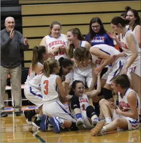  ?? CONTRIBUTI­NG PHOTOGRAPH­ER ?? Oneida teammates mob Jordan French after she sunk the game-winning shot in a 61-59 victory over RFA at home on Friday, Dec. 21.