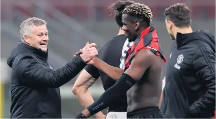  ??  ?? Good job:
Manchester United manager Ole Gunnar Solskjaer greets Paul Pogba after victory over AC Milan