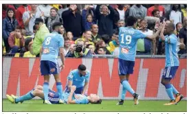  ?? (Photos AFP) ?? Les Olympiens peuvent remercier Ocampos, entré en cours de jeu, de les avoir sortis d’un bien mauvais pas.