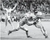  ?? DENNY SIMMONS USA TODAY Network ?? Derrick Henry gets past Dolphins safety Elijah Campbell for a touchdown Dec. 11 at Hard Rock Stadium. Henry is joining Lamar Jackson in the Baltimore Ravens’ backfield.