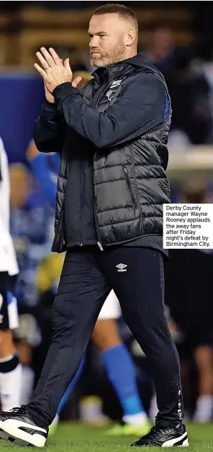  ??  ?? Derby County manager Wayne Rooney applauds the away fans after Friday night’s defeat by Birmingham City.