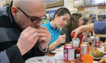  ?? ANDREW CHUNG/TORONTO STAR ?? Christian Bergeron of Trois Rivières, Que., dines at Schwartz’s on Tuesday. Céline Dion and husband René Angélil are among the investors who have bought the Montreal deli where the smoked meat comes piled high.