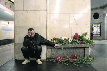  ?? Till Rimmele / EPA ?? A man at the Technologi­cal Institute metro station mourns for the victims of the bomb blast in Russia’s second-largest city.