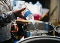  ?? Brett Coomer / Staff photograph­er ?? It’s hard to follow a boil-water notice when the power is out. That calls for a Jetboil flash cooking system or portable stove.