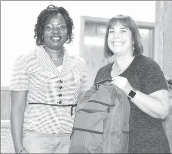  ?? Janice McIntyre/News-Times ?? Bags for school: Alexis Alexander, right, executive director of the United Way of Union County presented backpacks to for school children in the El Dorado School District. Kimberly Thomas, director of counseling for the ESD, accepted the bags on behalf...