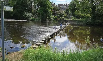  ?? Photograph: Paul Ellis/AFP/Getty Images ?? The River Wharfe in Ilkley is the only river in the UK with an area officially designated for bathing, although its water quality is deemed ‘poor’.