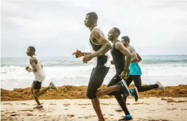  ?? Photo Credit: JANE HAHN FOR THE NEW YORK TIMES ?? Athletes running on Aberdeen Beach in Freetown. Sierra Leone’s national police force issued a ban for group jogging