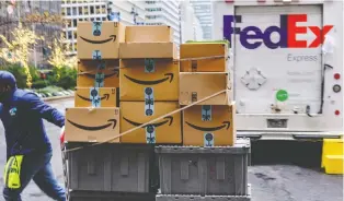  ?? CHRISTOPHE­R LEE/BLOOMBERG ?? A worker pushes Amazon packages in New York. Amazon has missed analyst estimates with its forecast of Q4 net sales from US$80 billion to US$86.5 billion for the crucial holiday quarter.