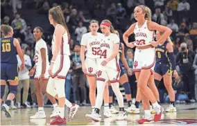  ?? ABBIE PARR/AP ?? Indiana players walk off the court during the final seconds of the team's loss to Michigan in a quarterfin­al game at the Big Ten women’s tournament Friday in Minneapoli­s.