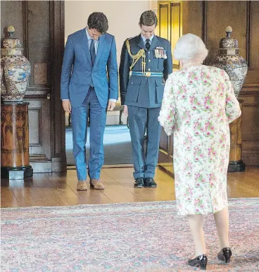  ?? RYAN REMIORZ / THE CANADIAN PRESS ?? Prime Minister Justin Trudeau bows Wednesday as he is introduced to Queen Elizabeth at Holyrood Palace, her official residence in Edinburgh.