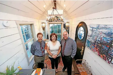  ?? [PHOTO BY STEVE GOOCH, THE OKLAHOMAN] ?? Odyssey Leadership Academy’s Headmaster Scott Martin, left, Sarah Horton and Brennan Will, chair of mathematic­s, stand inside the OLA tiny house.