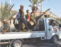  ?? AFP-Yonhap ?? Syrian pro-government forces drive in an armed vehicle in Deir Ezzor, Sunday, as they continue to press forward with Russian air cover in the offensive against Islamic State group jihadists across the province.