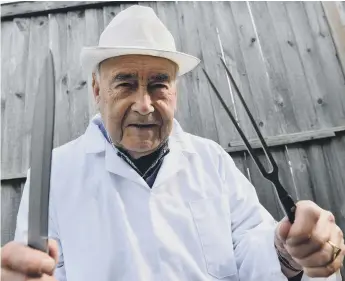  ??  ?? Ready for action: Houghton Feast traditiona­l ox roasting team member Ron Young, 91.