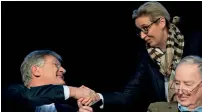  ?? AFP ?? AfD co-leader and top candidate for European elections Joerg Meuthen shakes hands with AfD parliament­ary group co-leader Alice Weidel during their party’s meeting in Riesa, Germany. —