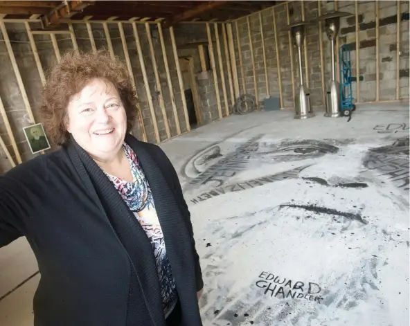  ?? PHOTOS: DAX MELMER ?? Mary Lambros stands over a portrait in progress of whisky baron Hiram Walker at the former Monarch Mattress building, which she is transformi­ng into a cultural hub.