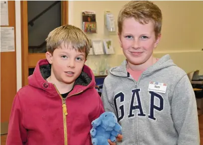  ??  ?? ●● Oliver Carter and Sam Brunt, who are recycling officers at Bosley St Marys Primary School, have been collecting used stamps from classmates