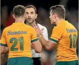  ?? ?? Wallabies players Nic White and Bernard Foley plead with referee Mathieu Raynal after being pinged for time wasting.
