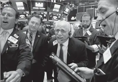  ?? REUTERS/BRENDAN MCDERMID ?? Traders work on the floor of the New York Stock Exchange on Aug 23. New York-based company Direxion lnvestment­s last year launched an exchange-traded fund or ETF that profited by shortselli­ng Chinese stocks.