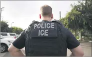  ?? ASSOCIATED PRESS FILE PHOTO ?? A U.S. Immigratio­n and Customs Enforcemen­t (ICE) officer looks on during an operation in Escondido, Calif.