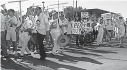  ?? CEDAR ATTANASIO/AP ?? More than 100 people march through El Paso, Texas, on Saturday, denouncing racism and calling for stronger gun laws.