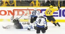  ?? Mark Humphrey / Associated Press ?? Nashville’s Kevin Fiala celebrates after scoring a goal against Winnipeg goalie Connor Hellebuyck in the second overtime.