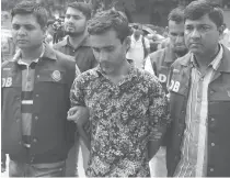  ??  ?? Bangladesh police parade suspect Shariful Islam Shihab (C) in Dhaka on May 15, after his arrest in connection with the murder of two gay rights activists.