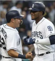  ?? AP PHOTO/KYUSUNG GONG ?? San Diego Padres’ Franchy Cordero (right) and Christian Villanueva celebrate Cordero’s three-run home run during the fourth inning of a baseball game against the New York Mets in San Diego, on Saturday.