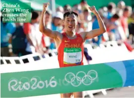  ??  ?? China’s Zhen Wang crosses the finish line